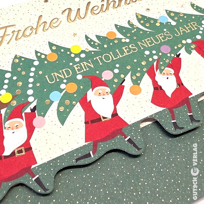 Eine Weihnachtsgrußkarte mit drei illustrierten Weihnachtsmännern, die einen großen grünen Baum tragen, der mit bunten Punkten verziert ist.